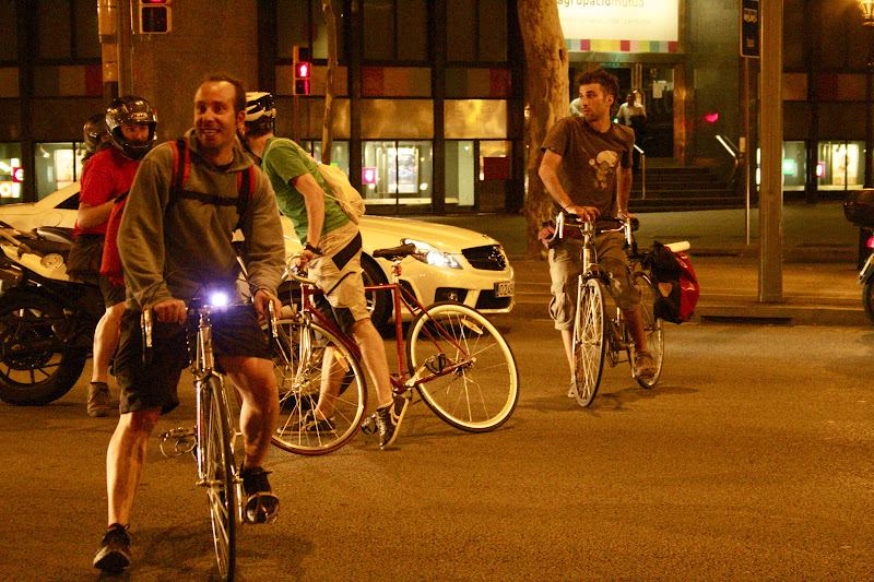 three cyclists stopped talking with the driver of a motorcycle
